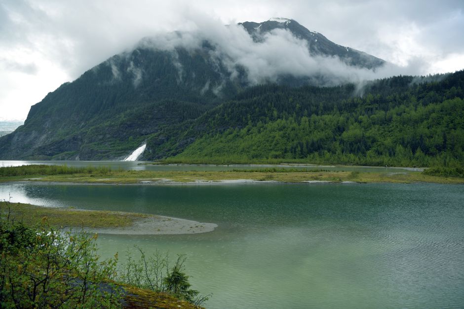 Breathtaking view of Mendenhall Glacier with lush greenery and serene lake in Juneau, Alaska.