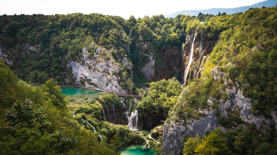 A stunning waterfall cascading through lush greenery at Plitvice Lakes National Park, Croatia.
